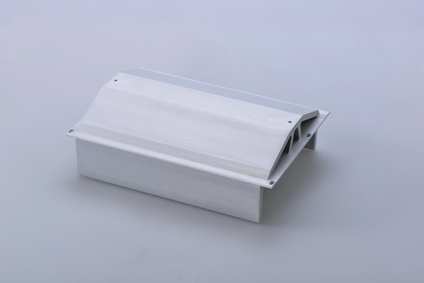 Silver aluminum extrusion profile with holes against a grey background.